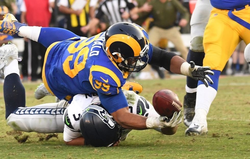 Aaron Donald sacking Russel Wilson and recovering a fumble.