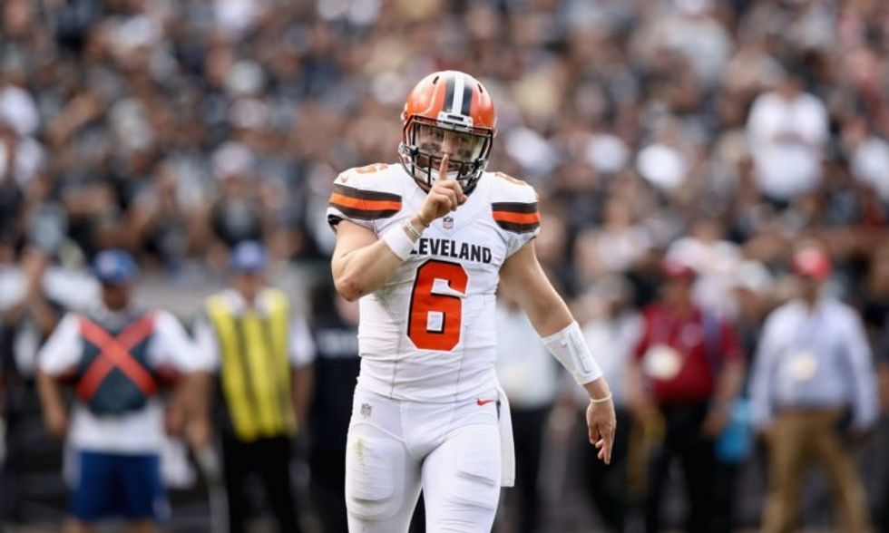 Baker Mayfield quiets the crowd after scoring a touchdown against the RRaiders on September 30, 2018 in Oakland, California.
