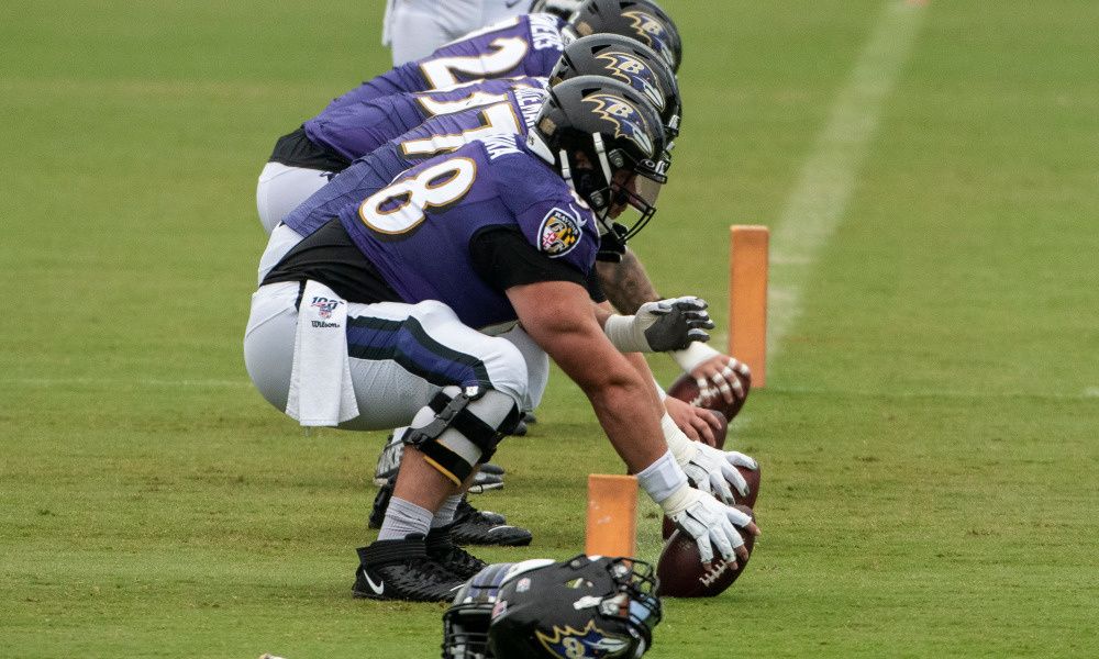 Baltimore Ravens centers practice snapping football