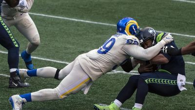 Aaron Donald dives to tackle Russell Wilson. 