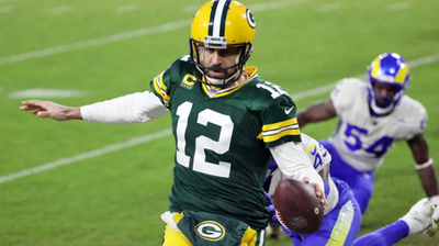 Aaron Rodgers sticks the nose of the football across the goal line to scramble for a touchdown.