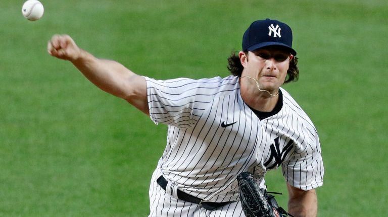 Gerrit Cole releases a baseball to fire a pitch in to the batter.