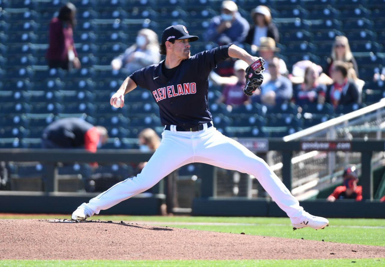 Shane Bieber is mid-delivery about to fire a pitch in to the batter.
