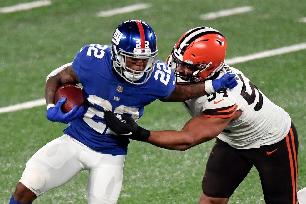 New York Giants running back Wayne Gallman (22) stiff-arms Cleveland Browns defensive end Olivier Vernon (54) in the second half.
