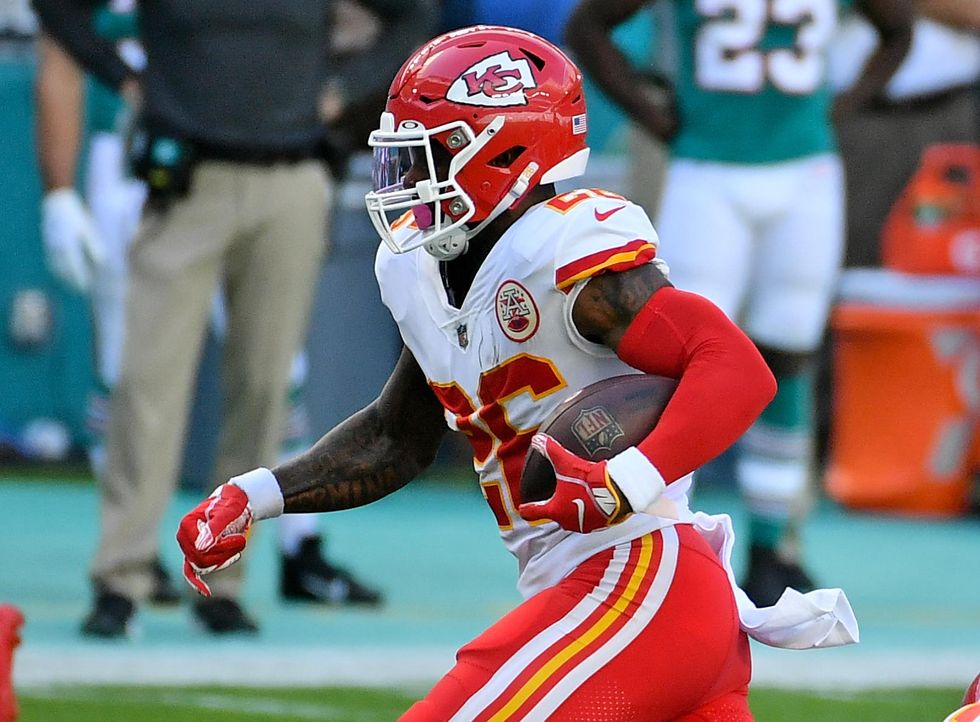 Kansas City Chiefs running back Le'Veon Bell (26) runs the ball against the Miami Dolphins during the first half at Hard Rock Stadium.