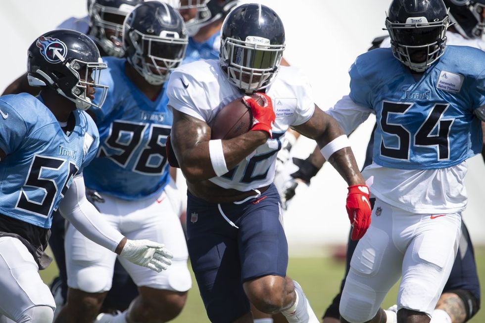 Derrick Henry running a football