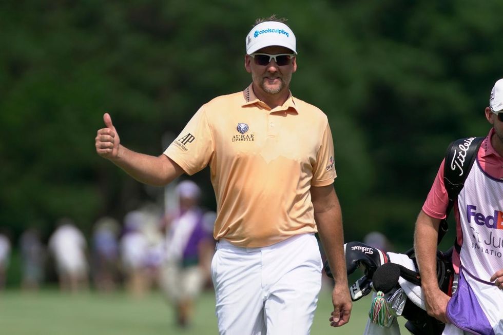 Ian Poulter all smiles after an approach to the green